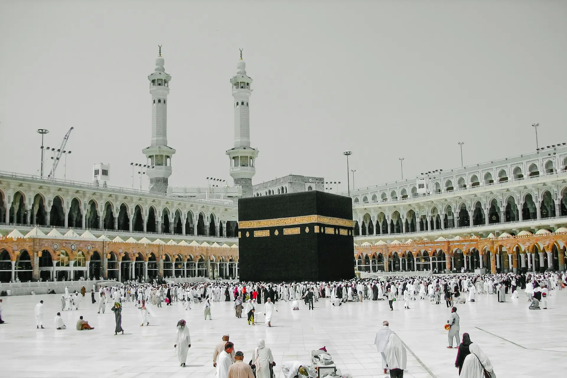 a group of people standing around a large building